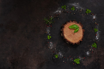 Condiments and spices on round wooden board. Top view, close-up on vintage wooden background