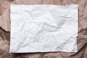 crumpled cream craft paper like a frame, and white paper, background texture