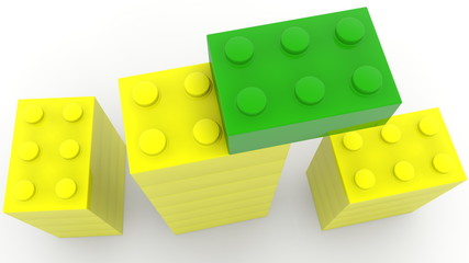 Top view on towers of toy bricks in green and yellow colors