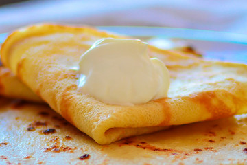 Pancakes with sour cream close up. Concept: a dish of flour, way of serving, still life.