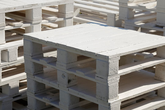 Pile of white wooden pallets