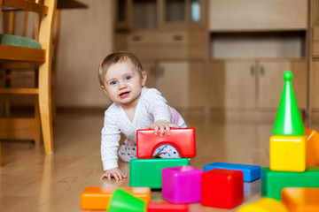 Baby with multi-colored designer at home