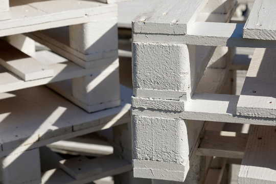 Stack of white painted wooden pallets