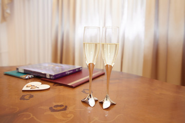 two champagne glasses on the wedding table