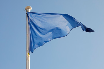 The blue triangular flag is placed on the mast
