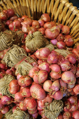 Vertical Image of Bunches of Fresh Red Onions in the Basket