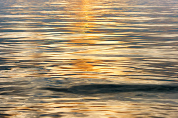 Water surface with golden color waves for backgrounds