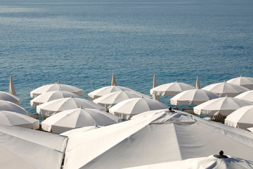 White umbrellas at the seashore