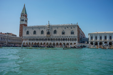 Fototapeta na wymiar Italy, Venice, Doge's Palace, a castle like building with people in the water with Doge's Palace in the background