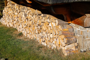 Firewood has been stacked at wall of house
