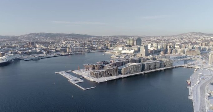4K high angle aerial view of the beautiful Oslo skyline, The Munch Museum called Lambda and Barcode, a part of the new Bj&oslash;rvika Opera quarter in Oslo, in vibrant winter sunlight.