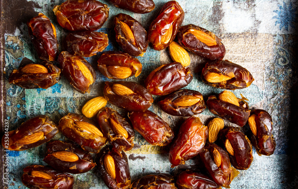 Poster fresh dates with almonds on a table
