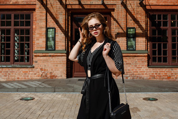Young and fashionable overweight woman walking around town