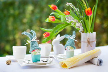 Easter breakfast with eggs and dekoration on a white table.