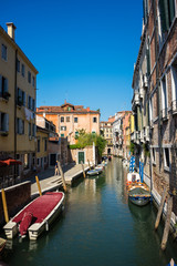 Obraz na płótnie Canvas Italy, Venice, a narrow canal in a city