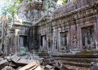 Fragment of the wall with apsara dancers stone carving  in the temple Ta Prohm in Angkor, Siem Reap, Cambodia