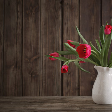 bouquet of red tulips on wooden background