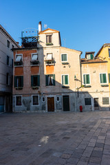 Italy, Venice, a close up of a street in front of a brick building