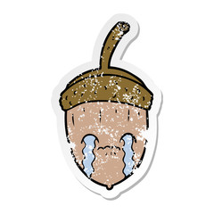 distressed sticker of a cartoon crying acorn
