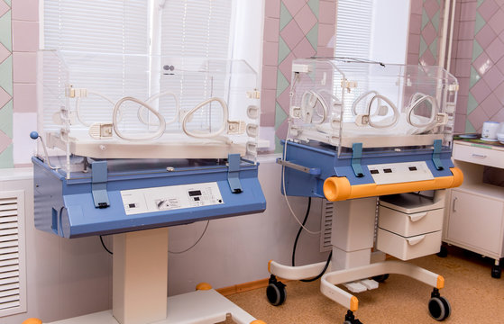 Empty Infant Incubator In An Hospital Room. Nursery Incubator In Hospital. Box For Carrying Premature Babies