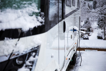 Electricity connection on a rv in the winter time. winter camping in the mountains. 