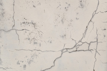 Cracked old wall with peeling white paint