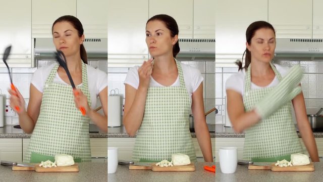 Young woman in apron dancing silly on kitchen with scapulas. Funny female enjoying herself moving ridiculously while preparing meal. Vertical video montage for mobile devices and social media