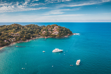 island in the sea with boats