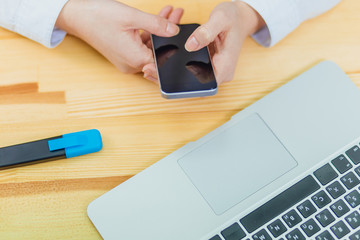 Top view of a shot from the hands of a person with the help of a smartphone in the interior, rear view of a business man busy using a mobile phone at the office desk, a young student, typing on the