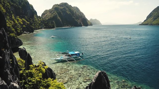 Matinloc shrine beautiful coast with black granite rocks and clear blue water in the philippines.
