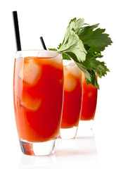Three Bloody Mary with ice cubes with celery isolated on white