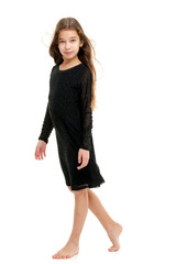 Little girl in a dress developing in the wind.