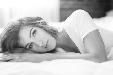 Beautiful woman lying in bed in the morning