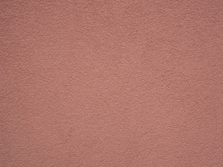 Rough pastel pink / red painted wall, stucco texture