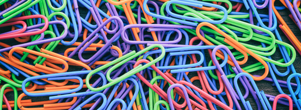 School, office supplies. Colorful paper clips background, banner © Rawf8