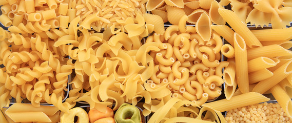 Uncooked various shapes pasta texture background, banner - Powered by Adobe