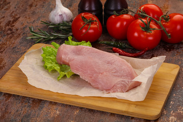 Raw Turkey steak served rosemary