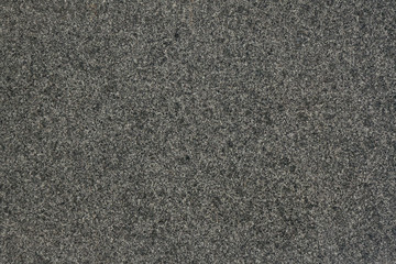 Grey granite background texture close up