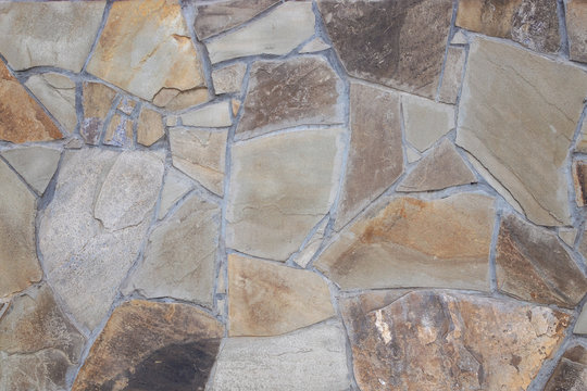 Fragment of wall from chipped stone. facing stone wall texture
