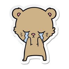 sticker of a crying cartoon bear
