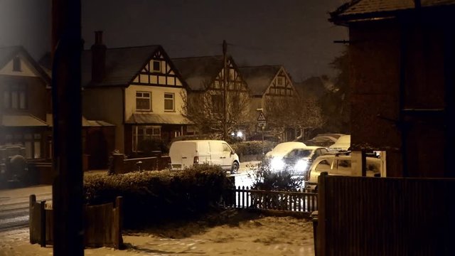 Snow falling on streets of Epsom, Surrey, Uk at night, winter scenic. Febr. 2018