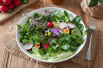 Salad with fresh broccoli and kale microgreens and pansies
