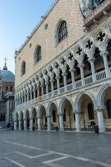 Fototapeta na wymiar Italy, Venice, Doge's Palace, a stone building that has a clock at the top of it with Doge's Palace in the background