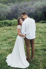 Young smiling couple holding on perfect landscape! Married people! Wedding time!