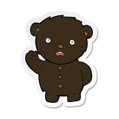 sticker of a cartoon unhappy black teddy bear