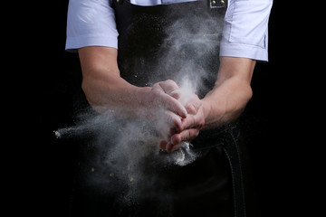 hand clap of chef with flour on black background isolated