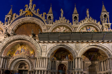 Fototapeta na wymiar Italy, Venice, St Mark's Basilica at night, a church with a clock on the front of St Mark's Basilica