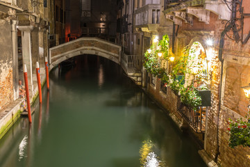 Italy, Venice, Venetian Ghetto, BRIDGE OVER CANAL AMIDST ILLUMINATED BUILDINGS AT NIGHT