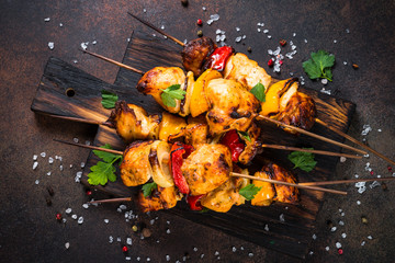 Chicken kebab  with vegetables on skewers top view.