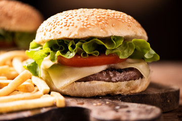 Homemade burger on wooden background.